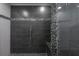 Modern shower features gray tile and stone accents at 6108 Oak Ridge Ave, New Port Richey, FL 34653