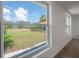 Window view of a grassy backyard with a black fence at 6108 Oak Ridge Ave, New Port Richey, FL 34653