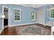 Bright bedroom with hardwood floors, plantation shutters, and an adjacent bathroom at 6220 Bayshore Blvd, Tampa, FL 33611