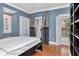 Comfortable bedroom with hardwood floors, natural light, and sophisticated curtains at 6220 Bayshore Blvd, Tampa, FL 33611