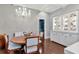 Cozy dining area featuring a lovely display cabinet, hardwood floors, and elegant lighting at 6220 Bayshore Blvd, Tampa, FL 33611