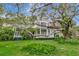 Sprawling two-story home showcasing an expansive porch and mature trees at 6220 Bayshore Blvd, Tampa, FL 33611