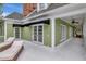 Exterior of a charming home, with french doors, and a bright green painted exterior at 6220 Bayshore Blvd, Tampa, FL 33611