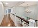 Grand hallway showcasing hardwood floors, a chandelier, and beautiful architectural details at 6220 Bayshore Blvd, Tampa, FL 33611