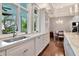 Gourmet kitchen with marble counters, custom cabinetry, stainless steel appliances, and large windows at 6220 Bayshore Blvd, Tampa, FL 33611