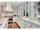 Gourmet kitchen with stainless steel appliances, marble countertops, custom cabinetry, and hardwood floors at 6220 Bayshore Blvd, Tampa, FL 33611