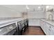 Well-lit laundry room with modern washer/dryer units and elegant marble countertops at 6220 Bayshore Blvd, Tampa, FL 33611