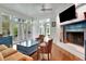 A living room with a fireplace, french doors to the outside, wood floors, and ceiling fan at 6220 Bayshore Blvd, Tampa, FL 33611