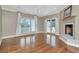 A living room with a fireplace, wood floors, ceiling fan, and access to a covered porch at 6220 Bayshore Blvd, Tampa, FL 33611
