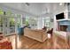 A living room with a fireplace, french doors to the outside, wood floors, and ceiling fan at 6220 Bayshore Blvd, Tampa, FL 33611