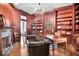An office featuring custom wood trim, shelving, wood floors and a leather couch at 6220 Bayshore Blvd, Tampa, FL 33611