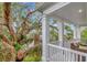 A covered porch with columns offers serene views of lush landscaping at 6220 Bayshore Blvd, Tampa, FL 33611