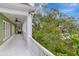A white porch with columns offers serene views of lush landscaping at 6220 Bayshore Blvd, Tampa, FL 33611