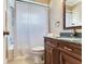 Bathroom features a dark vanity, granite countertop and shower with white shower curtain at 6360 1St N St # 202, St Petersburg, FL 33702