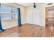 Bedroom featuring hardwood floors, a closet, and windows with blinds and curtains at 6360 1St N St # 202, St Petersburg, FL 33702