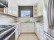 Bright kitchen features white cabinets, stainless steel appliances, and natural light at 6360 1St N St # 202, St Petersburg, FL 33702