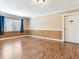 Bright living room with hardwood floors, natural light through the window, and white door at 6360 1St N St # 202, St Petersburg, FL 33702