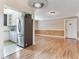 Open-concept living area featuring hardwood floors and neutral wall colors, adjacent to the kitchen space at 6360 1St N St # 202, St Petersburg, FL 33702