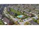 Aerial view of townhomes, with community pool and playground, showcasing the neighborhood's layout and amenities at 6909 Holly Heath Dr, Riverview, FL 33578