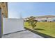 A fenced back patio with a concrete slab, a small tree, and a view of the green space in the backyard at 6909 Holly Heath Dr, Riverview, FL 33578