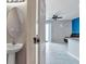 Half bathroom with a pedestal sink and modern fixtures, near the main living area at 6909 Holly Heath Dr, Riverview, FL 33578