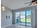 Sunlit dining area with tile flooring, sliding glass doors to the patio, and modern ceiling fan at 6909 Holly Heath Dr, Riverview, FL 33578