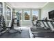 Bright gym with natural light, tile floors, and modern exercise equipment at 6909 Holly Heath Dr, Riverview, FL 33578