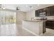 Bright kitchen with stainless appliances, center island, and sliding glass door to patio at 6909 Holly Heath Dr, Riverview, FL 33578