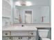 Well lit bathroom with large mirror, white vanity, and toilet at 7000 Lafayette N, Pinellas Park, FL 33781