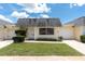 Inviting front exterior of home featuring an attached garage, tidy lawn and neutral paint at 7000 Lafayette N, Pinellas Park, FL 33781