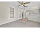 Living room features a ceiling fan, built in shelves, and view of the kitchen at 7000 Lafayette N, Pinellas Park, FL 33781