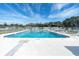 Large community pool with plenty of lounge chairs and a clear blue sky above at 7000 Lafayette N, Pinellas Park, FL 33781