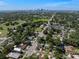 Aerial shot showcasing the neighborhood with lush greenery and the city skyline in the distance at 702 W Kentucky Ave, Tampa, FL 33603