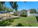 Spacious backyard featuring a brick patio with outdoor seating and well-maintained lawn at 702 W Kentucky Ave, Tampa, FL 33603