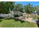 Well-manicured backyard with a patio, fire pit, and lush landscaping at 702 W Kentucky Ave, Tampa, FL 33603