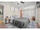 Cozy bedroom featuring a queen-sized bed, decorative pillows, neutral walls, and integrated closet space at 702 W Kentucky Ave, Tampa, FL 33603
