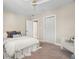 Cozy bedroom with soft carpet, ceiling fan, and lots of natural light at 702 W Kentucky Ave, Tampa, FL 33603