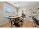 Bright dining room with a wooden table, bench seating, modern lighting fixture, and stylish decor at 702 W Kentucky Ave, Tampa, FL 33603