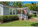 Well-maintained home featuring an inviting front porch, neat landscaping, and a brick walkway at 702 W Kentucky Ave, Tampa, FL 33603