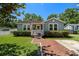 Charming home with a welcoming front porch, tidy landscaping, and brick walkway at 702 W Kentucky Ave, Tampa, FL 33603
