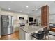 Kitchen with granite countertops, stainless steel appliances, and a brick support column at 702 W Kentucky Ave, Tampa, FL 33603
