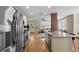 Open kitchen flows to living room with stainless appliances and granite countertops at 702 W Kentucky Ave, Tampa, FL 33603