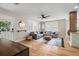Comfortable living room with hardwood floors, a large sectional, and plenty of natural light at 702 W Kentucky Ave, Tampa, FL 33603