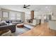 Open floor plan with hardwood floors, a cozy sectional, and a brick support column at 702 W Kentucky Ave, Tampa, FL 33603