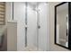 Clean shower featuring subway tile surround, mosaic floor tile, glass enclosure, and sleek fixtures at 702 W Kentucky Ave, Tampa, FL 33603