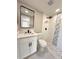 Bathroom features modern vanity, decorative floor, and updated shower with stylish tile at 7314 Ivanhoe Dr, Port Richey, FL 34668