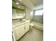 Bathroom features modern vanity, ceramic tile floor, and updated shower and tub at 7314 Ivanhoe Dr, Port Richey, FL 34668