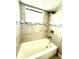 Bathroom features modern tub with ceramic tile walls and shower head at 7314 Ivanhoe Dr, Port Richey, FL 34668