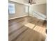 Spacious bedroom with wood-look floors and natural light from multiple windows at 7314 Ivanhoe Dr, Port Richey, FL 34668