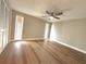 Spacious bedroom with wood-look floors, a ceiling fan, and natural light from windows at 7314 Ivanhoe Dr, Port Richey, FL 34668